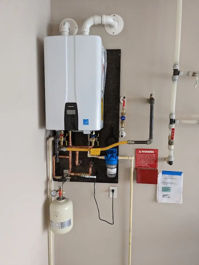 Professional plumber installing copper piping in a Evergreen home